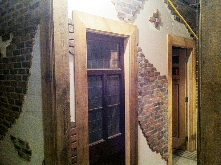 Distressed faux brick walls and wood framing at Patron Tacos & C